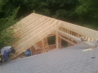 Framing a new roof addition that ties into an existing shingle roof in Milan
